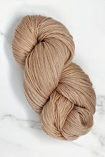 Load image into Gallery viewer, hand-dyed yarn in a semi-solid colorway, tan with the faintest hint of pink overtone
