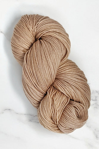 hand-dyed yarn in a semi-solid colorway, tan with the faintest hint of pink overtone
